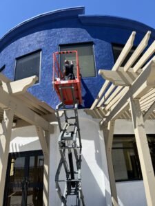 Commercial cleaning crew using an aerial lift to clean high-rise windows