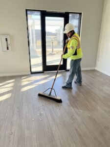 Cleaning business crew member completing a large commercial post-construction cleaning job